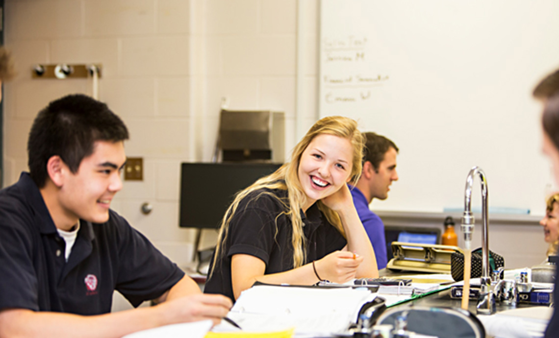 secondary school studnets in a science lab working on school work